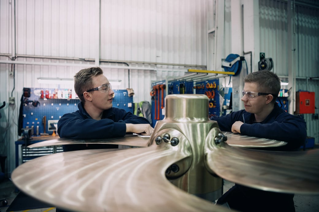 Two men working on a propeller