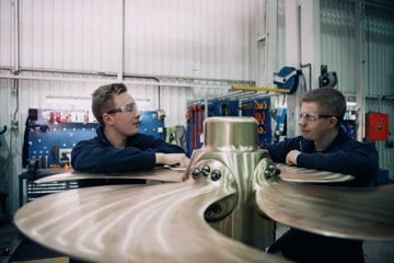 Two men working on a propeller