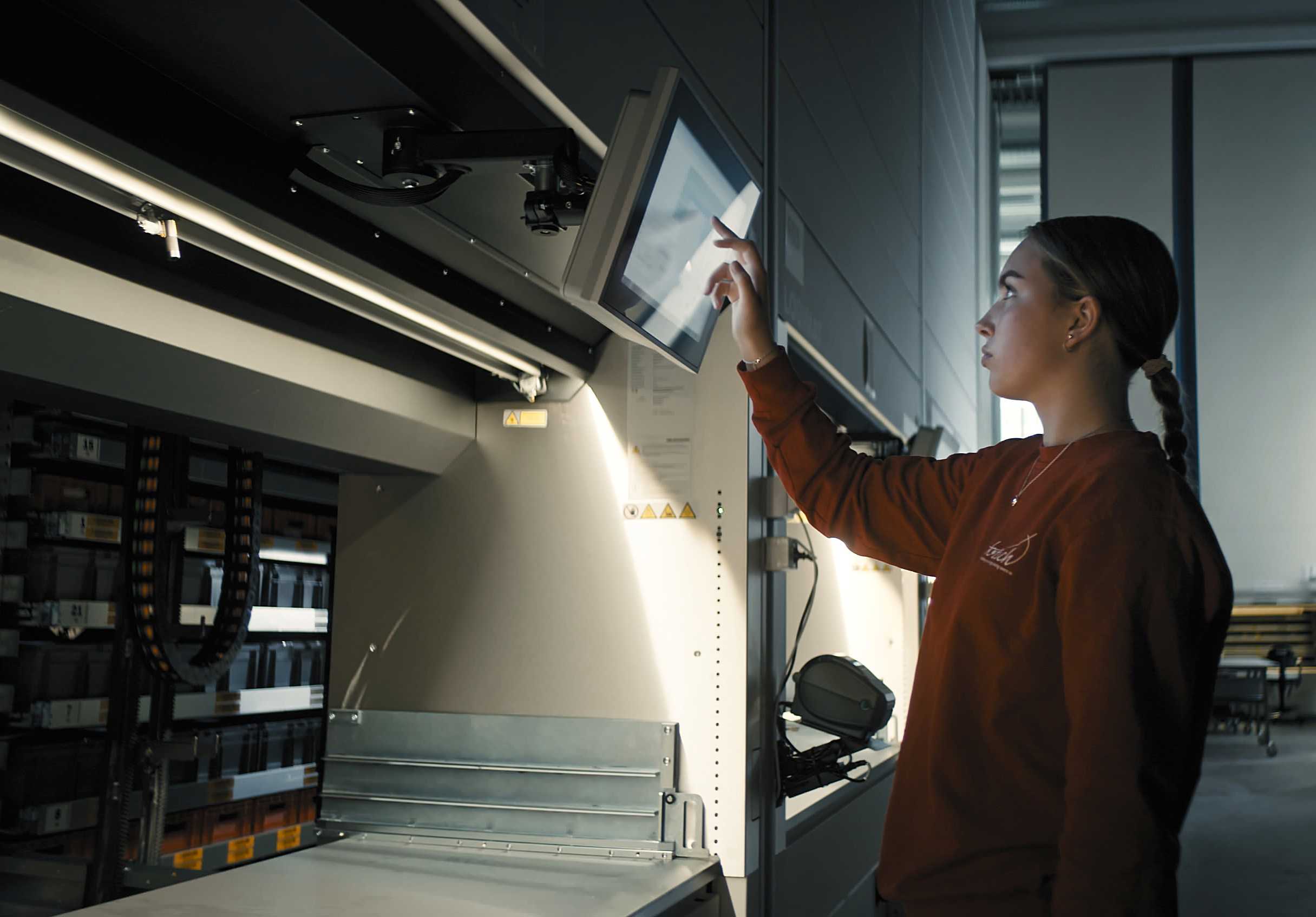 Woman using technology for picking up parts at KONGSBERG