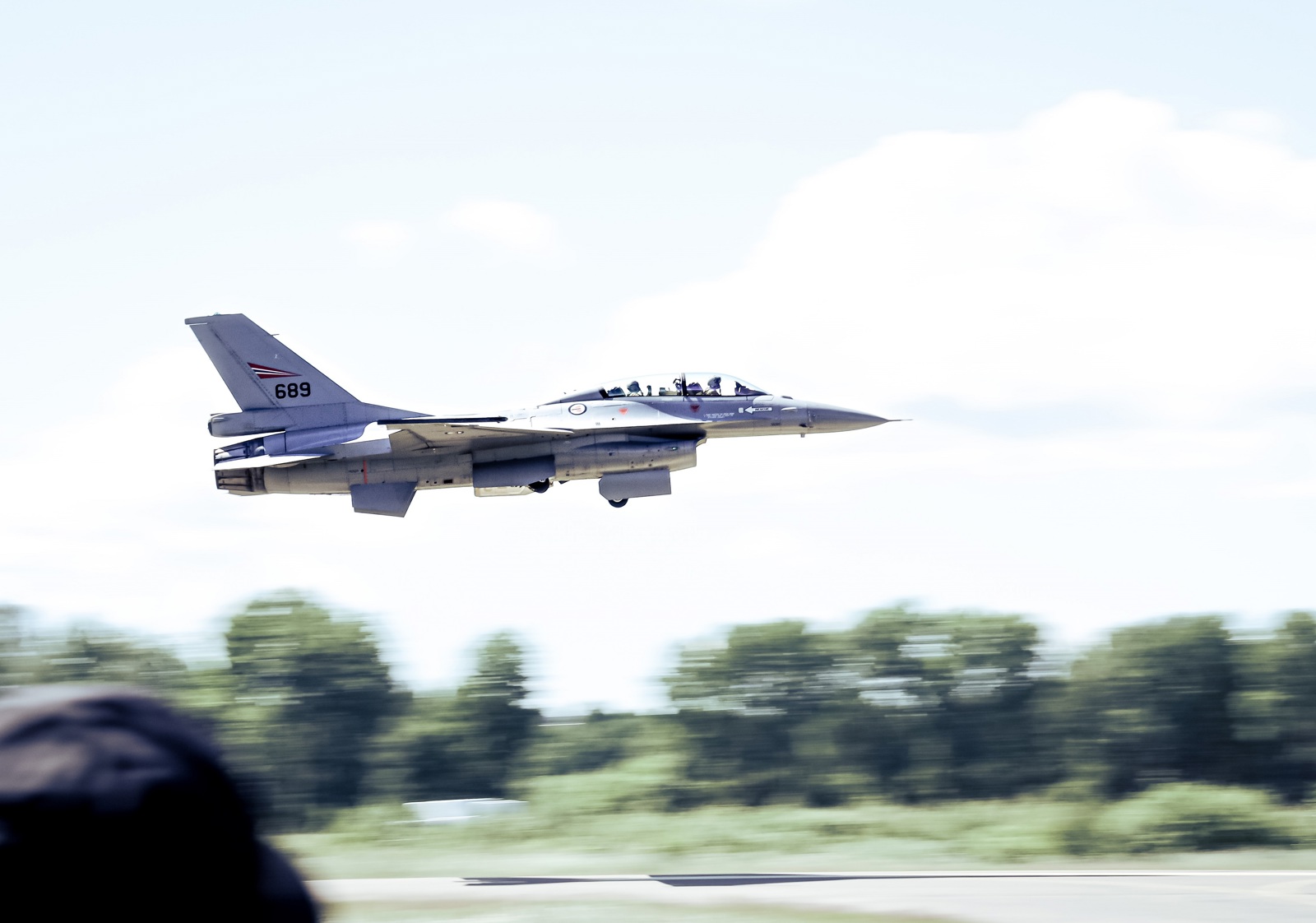 F-16 aircraft in flight, flying low at airport