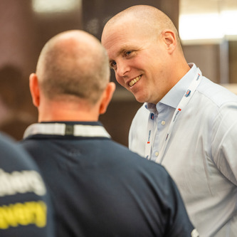 Two people talking at a conference