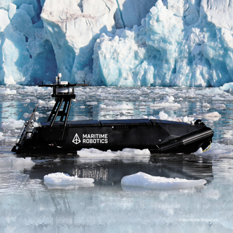 Image of an uncrewed surface vessel at sea surrounded by ice