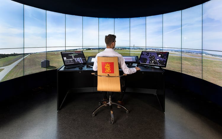 Man sitting in a KONGSBERG control room for aviation