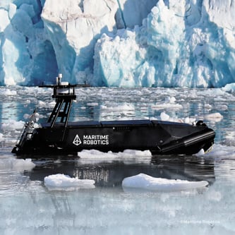 Image of an uncrewed surface vessel at sea surrounded by ice