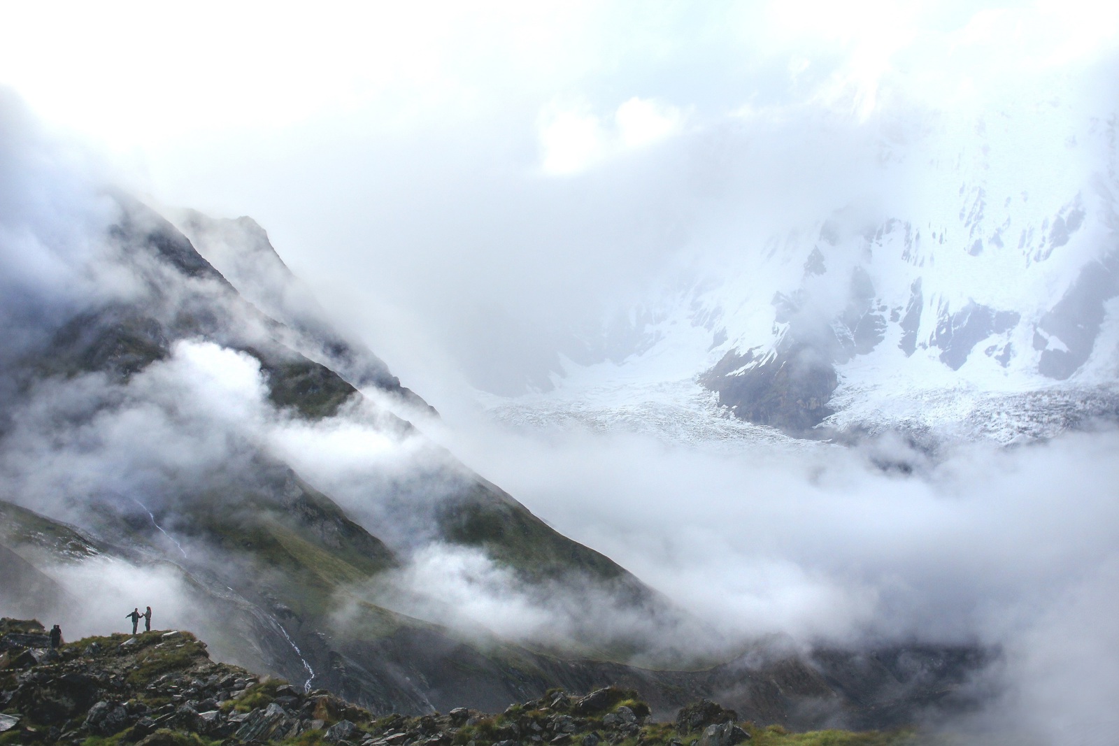 Snow-covered mountains with two people