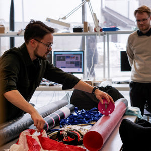 Image of a man working with rocket components