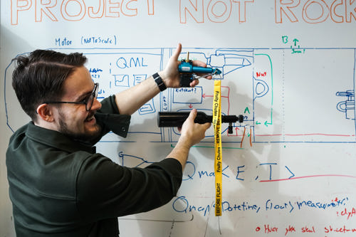 Image of man in front of whiteboard
